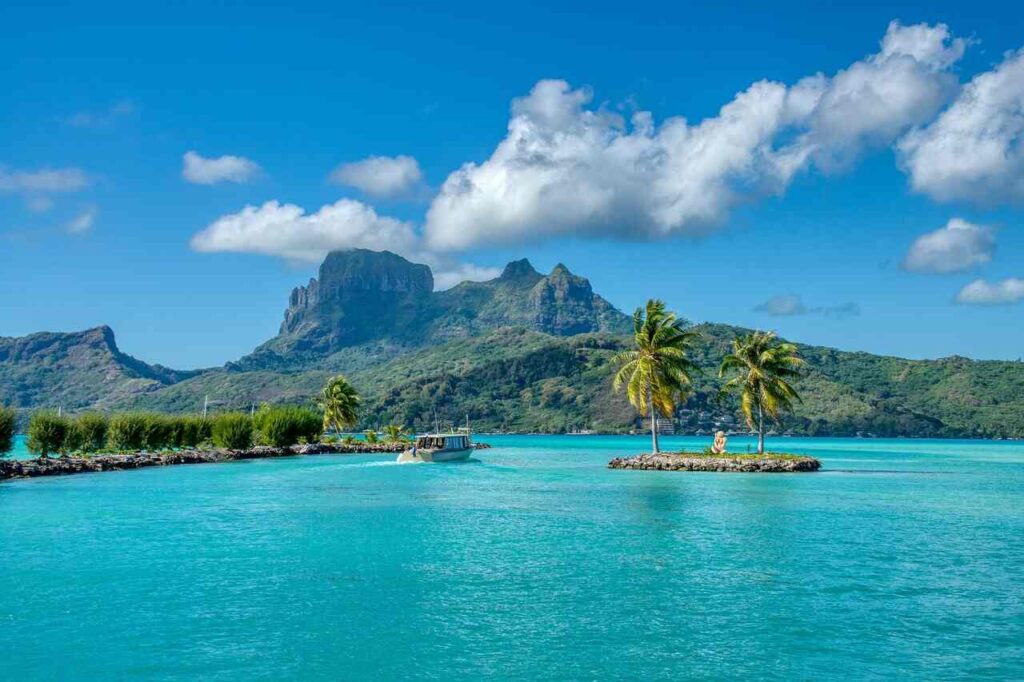 Tropical places on island with blue water and green mountains.